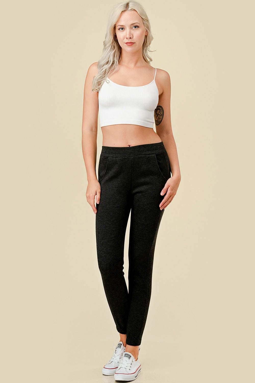 Women’s fleece lined black jogger sweatpants with side pockets, and slim tapered ankle fit