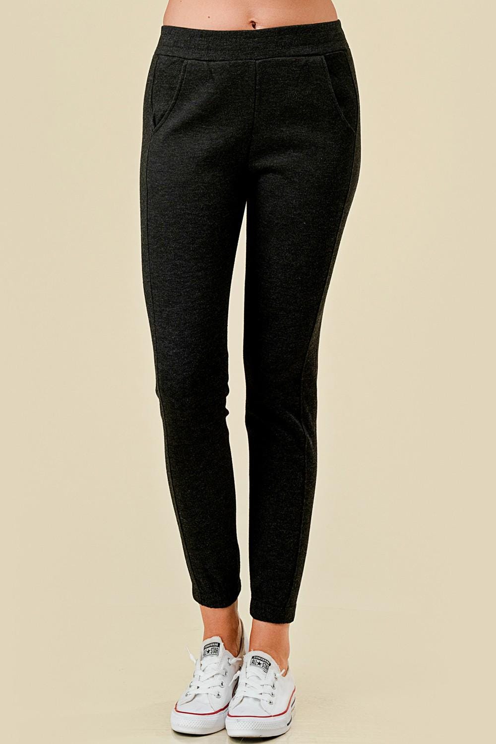 Women’s fleece lined black jogger sweatpants with side pockets, and slim tapered ankle fit