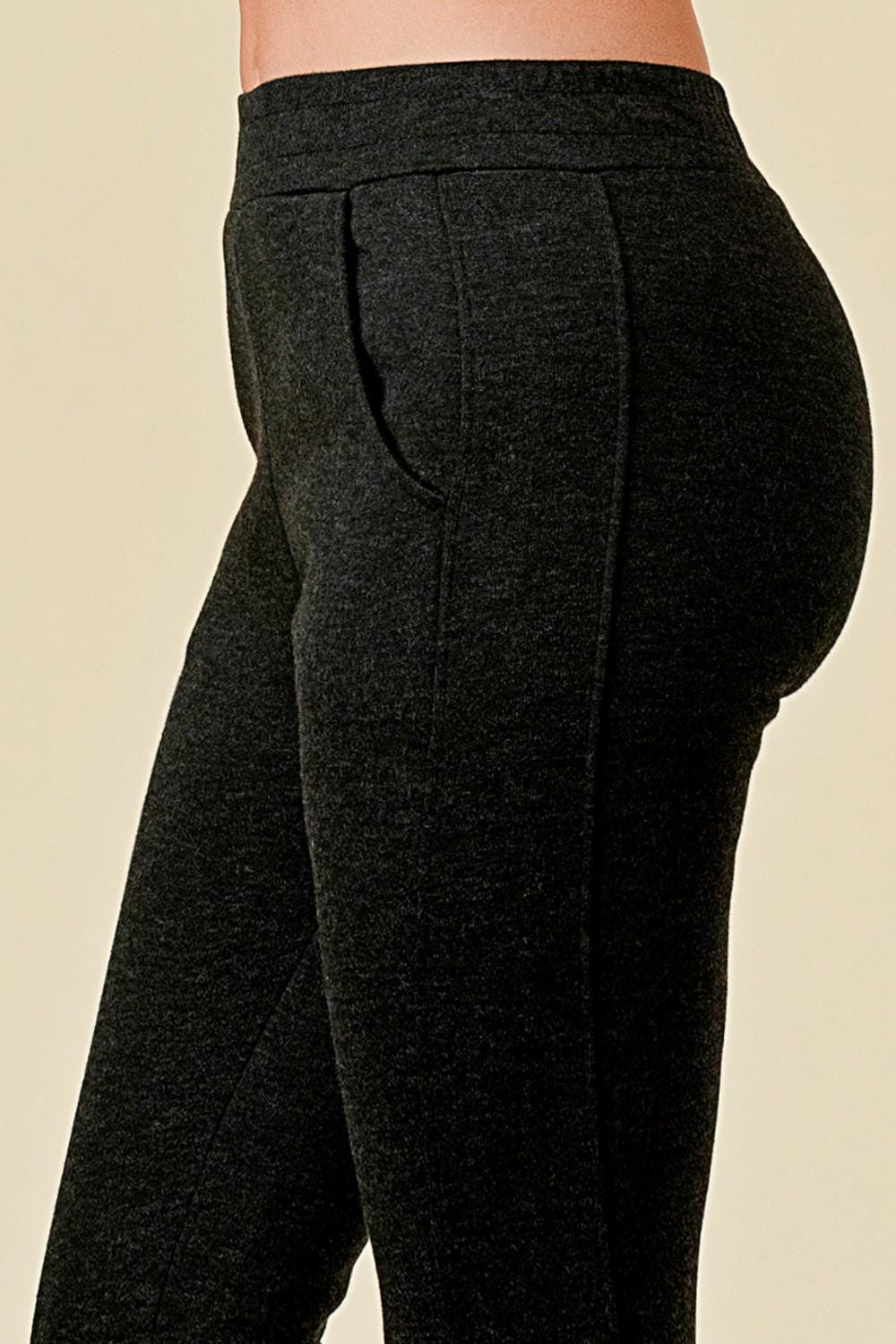 Women’s fleece lined black jogger sweatpants with side pockets, and slim tapered ankle fit