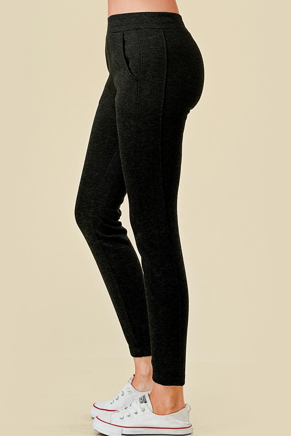 Women’s fleece lined black jogger sweatpants with side pockets, and slim tapered ankle fit