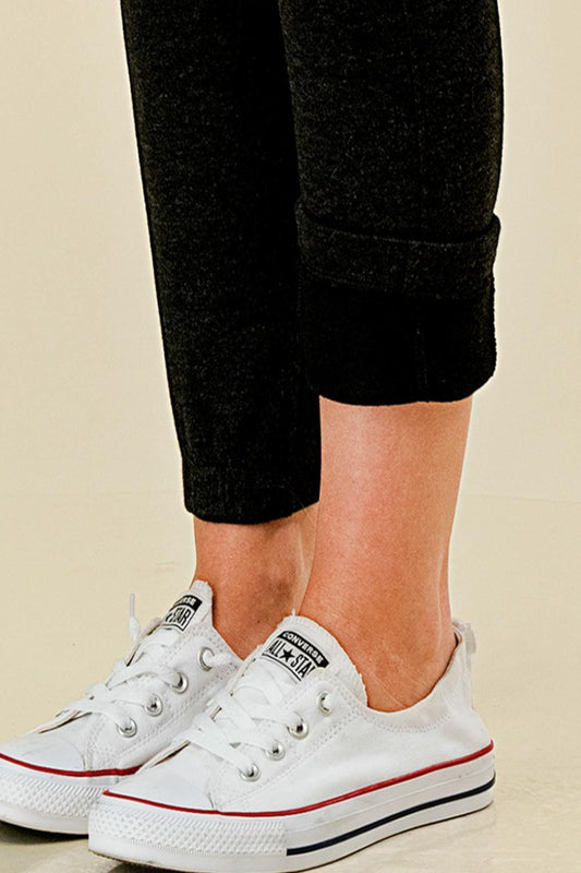 Women’s fleece lined black jogger sweatpants with side pockets, and slim tapered ankle fit